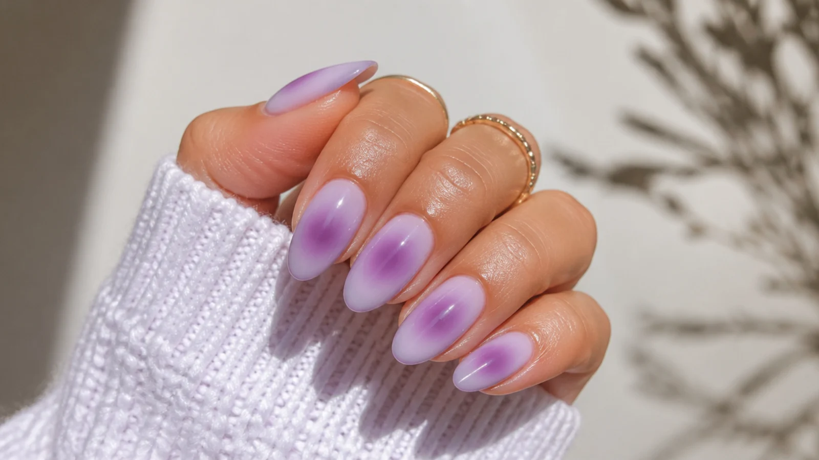 Lavender aura almond nails with a soft glowing center halo