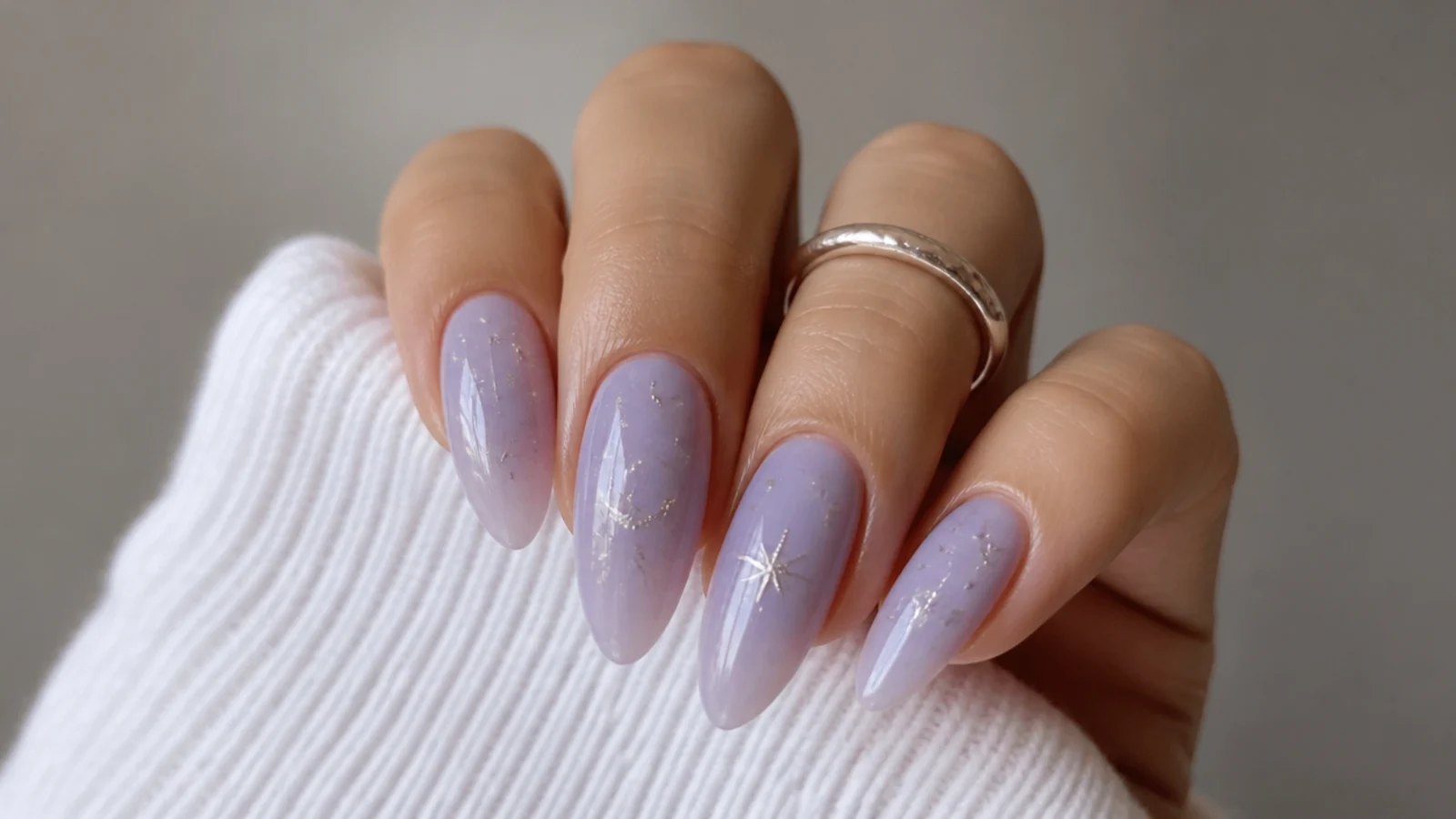 Milky lavender almond nails with tiny silver star and celestial accents