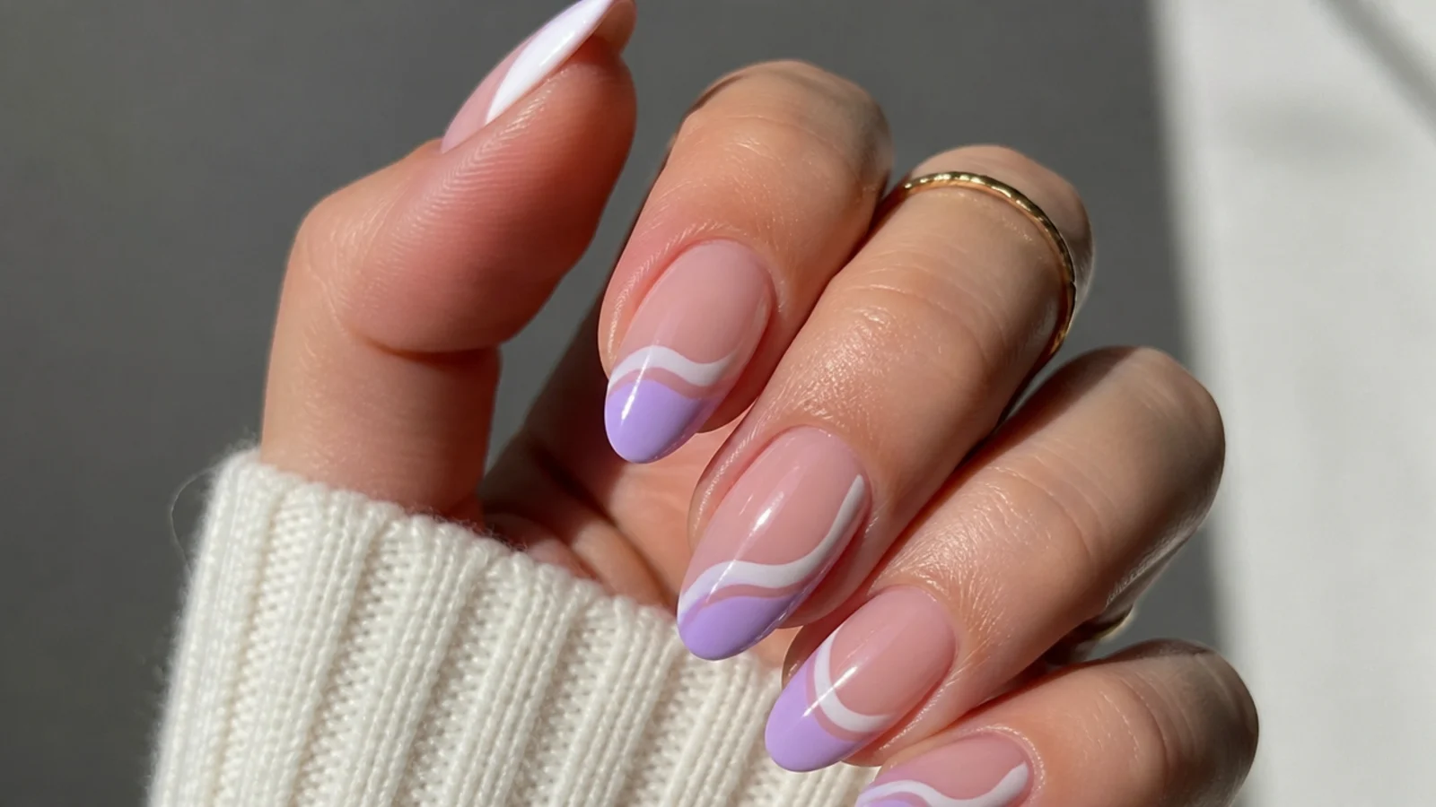 Sheer almond nails with lavender and white swirl tips