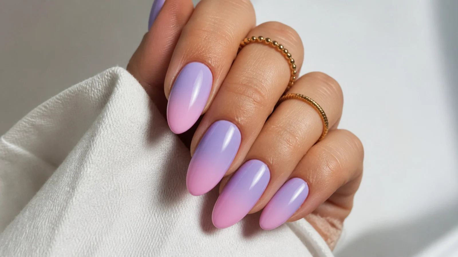 Lavender to soft pink ombre almond nails fading between the two pastels