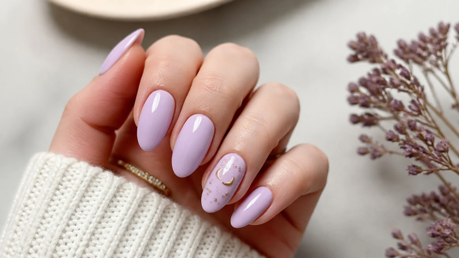 Soft lavender almond nails in a milky lilac shade on a light background