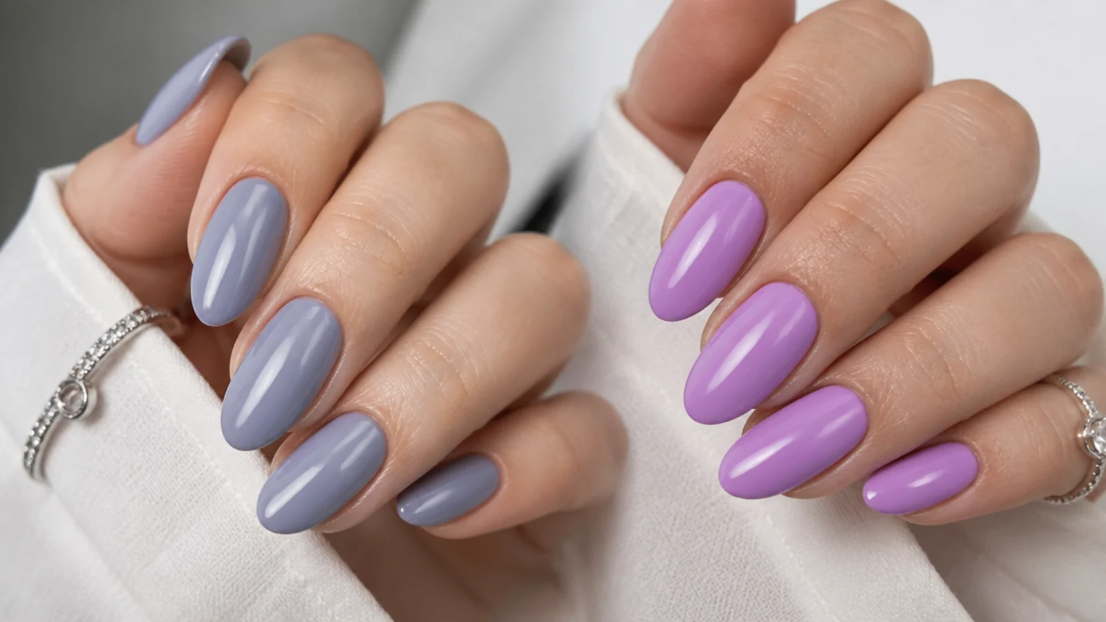 Soft gray-blue lavender nails beside a brighter light purple for comparison