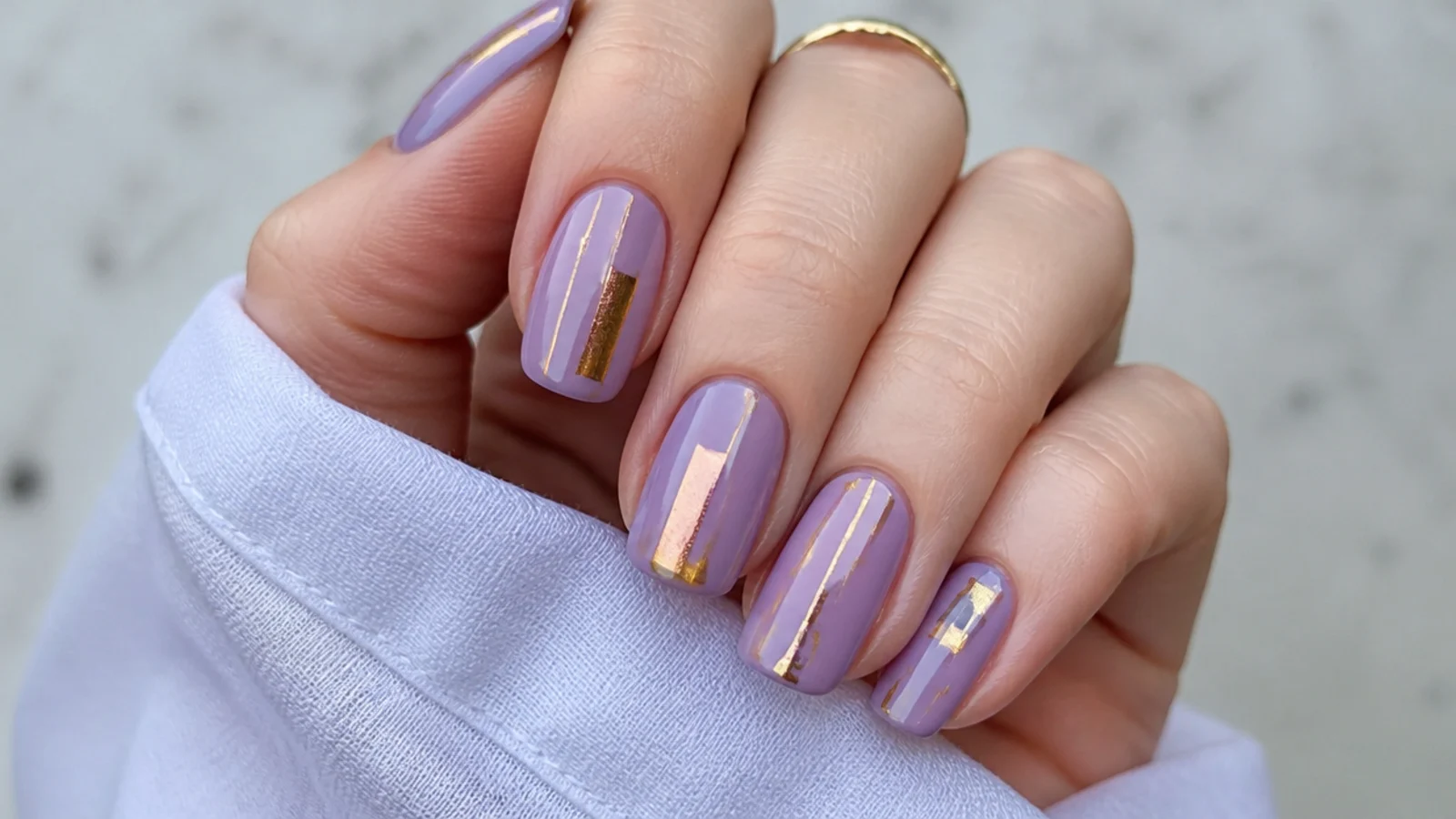 Lavender nails with abstract gold foil blocks and lines