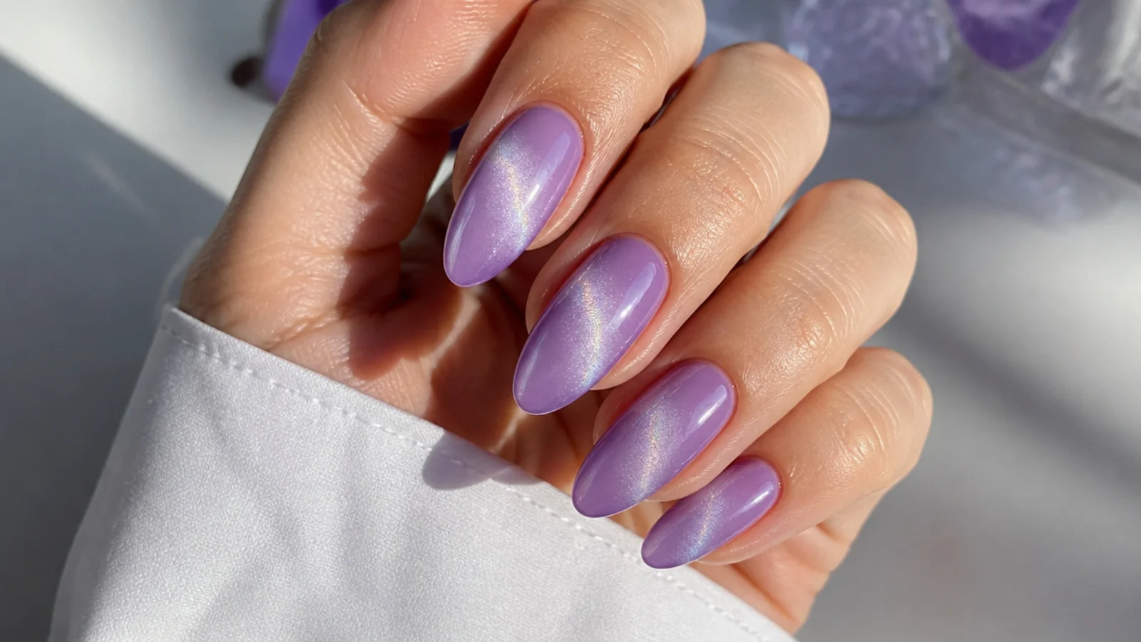 Lavender ombre cat eye nails fading from pale to deep lilac with a light streak