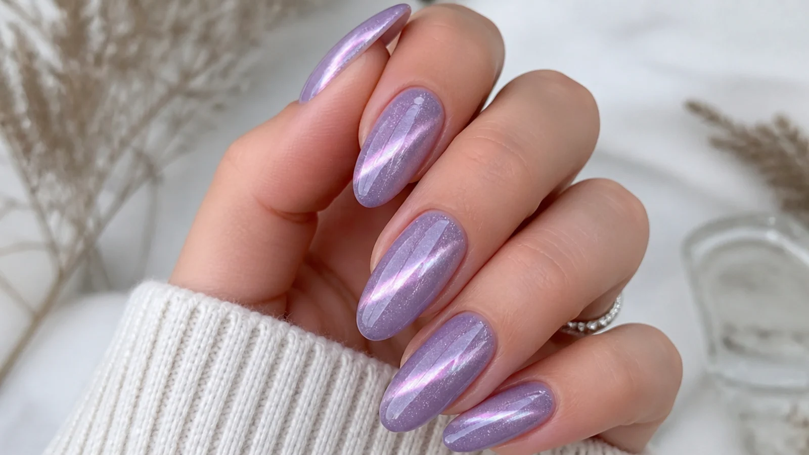 Lavender cat eye nails with fine silver glitter and a bright light streak