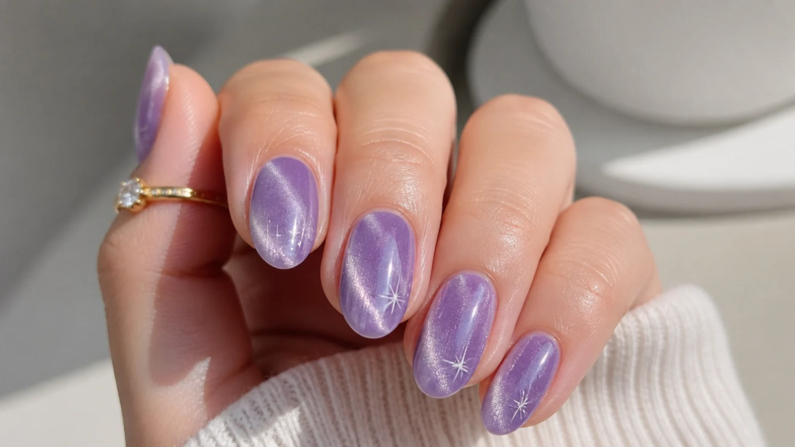 A well-sealed lavender cat eye manicure with cuticle oil for longevity