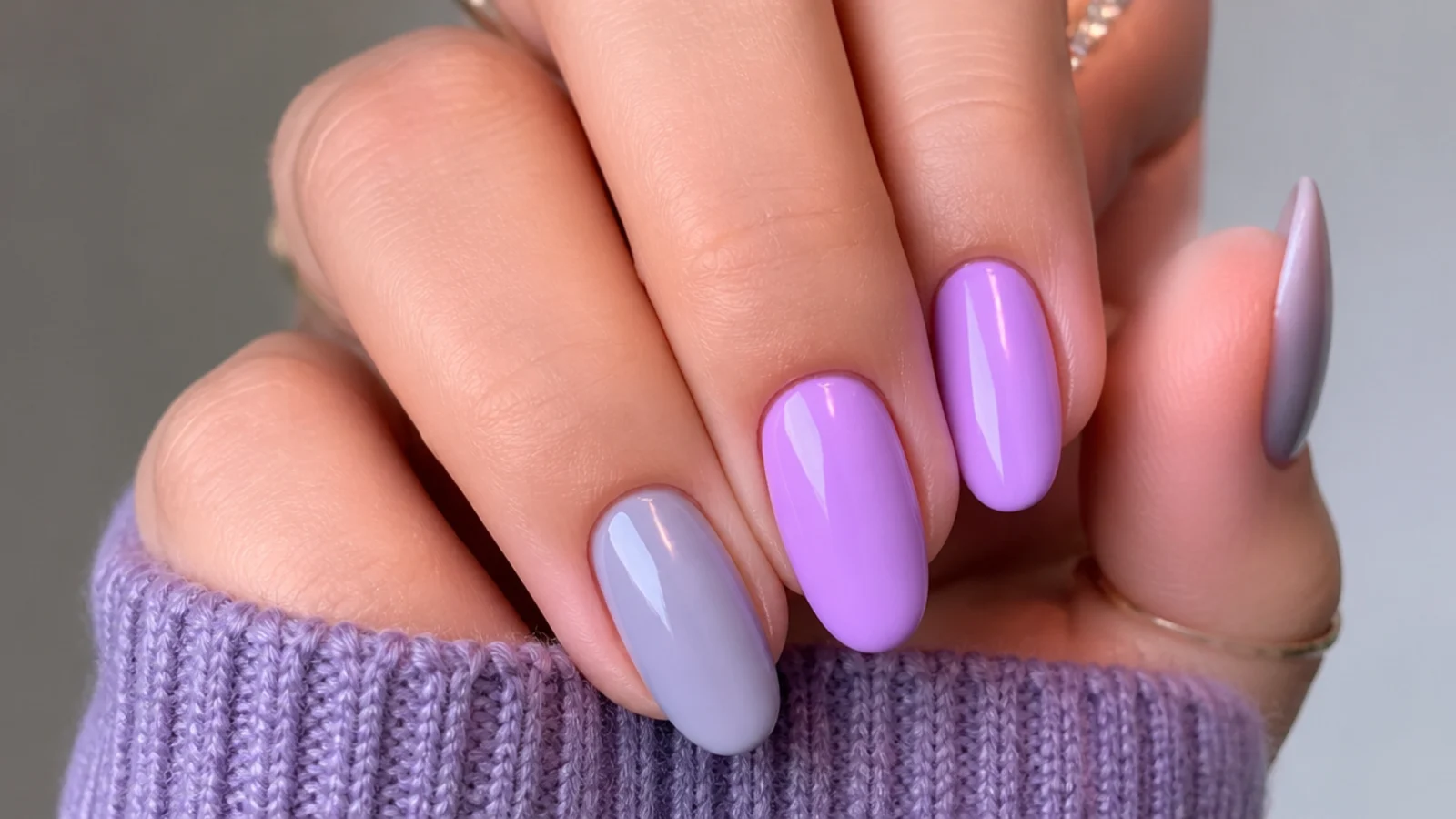 Soft gray-blue lavender nail beside a brighter light purple nail for comparison