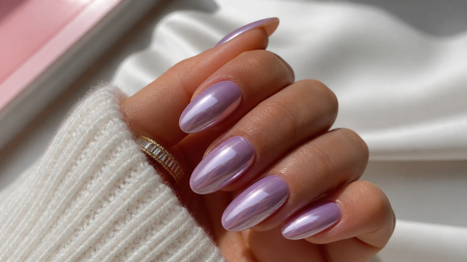 Warm pink-toned lavender chrome nails on tan skin