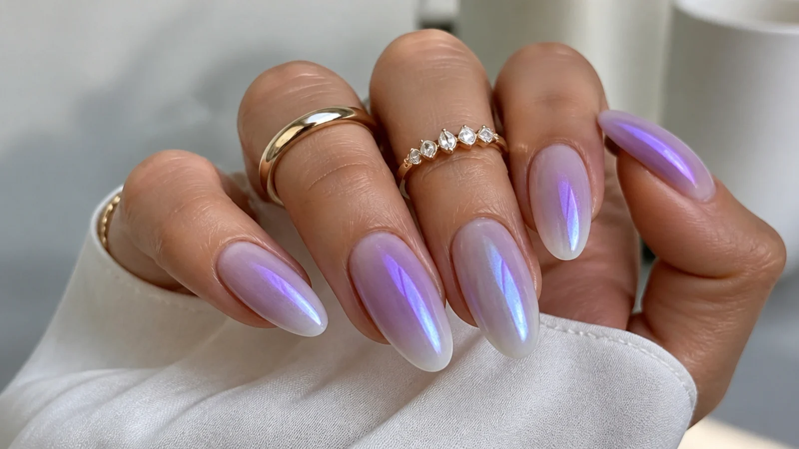 Lavender to white ombre chrome nails fading at the cuticle