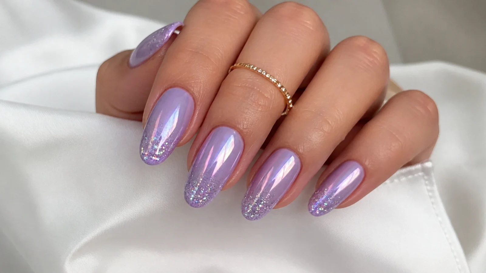 Lavender chrome nails with fine iridescent glitter over the tips
