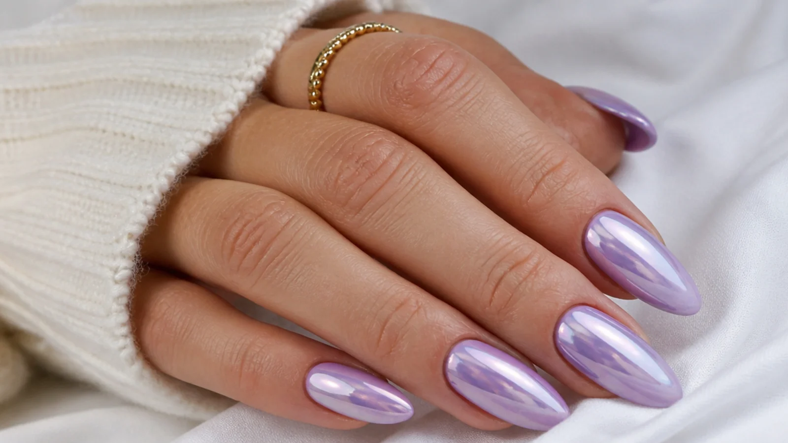 Soft lavender chrome nails with a mirror shine on an almond shape