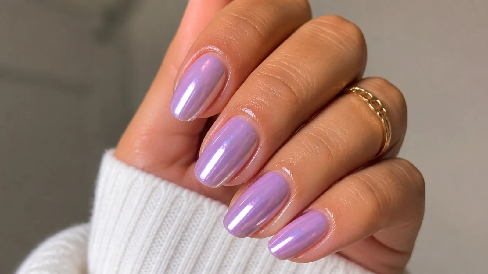 A sealed lavender chrome manicure with cuticle oil for longevity