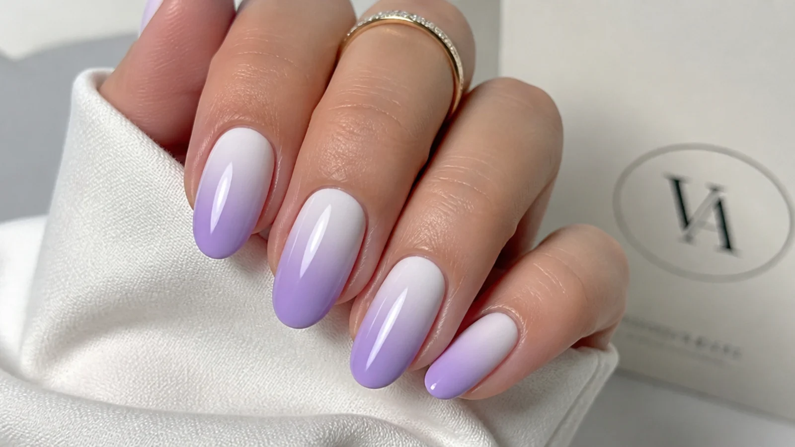 Lavender ombre nails fading from white at the cuticle to lilac at the tips