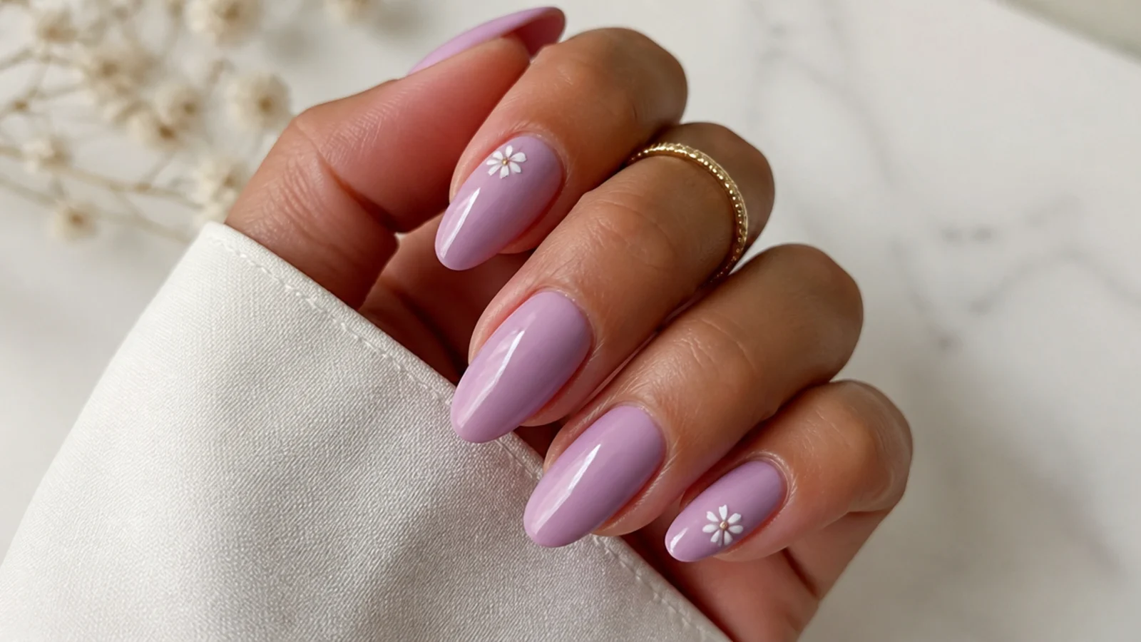 Warm pink-toned lavender nails on tan skin with a soft glossy finish