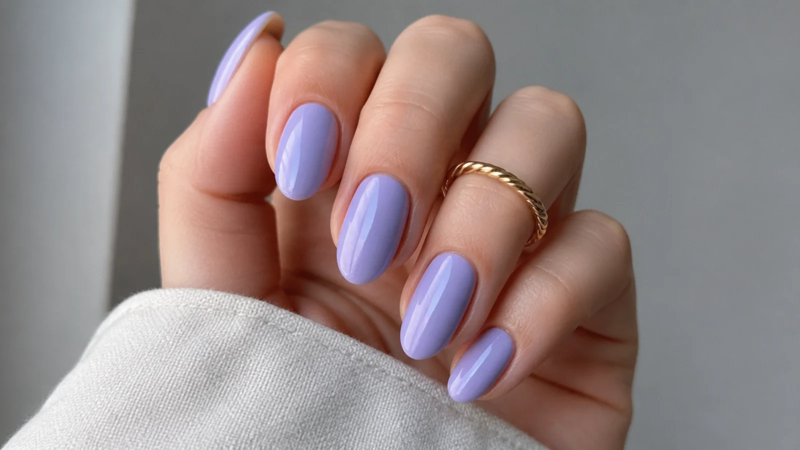 Cool blue-toned true lavender nails on fair skin with a glossy finish