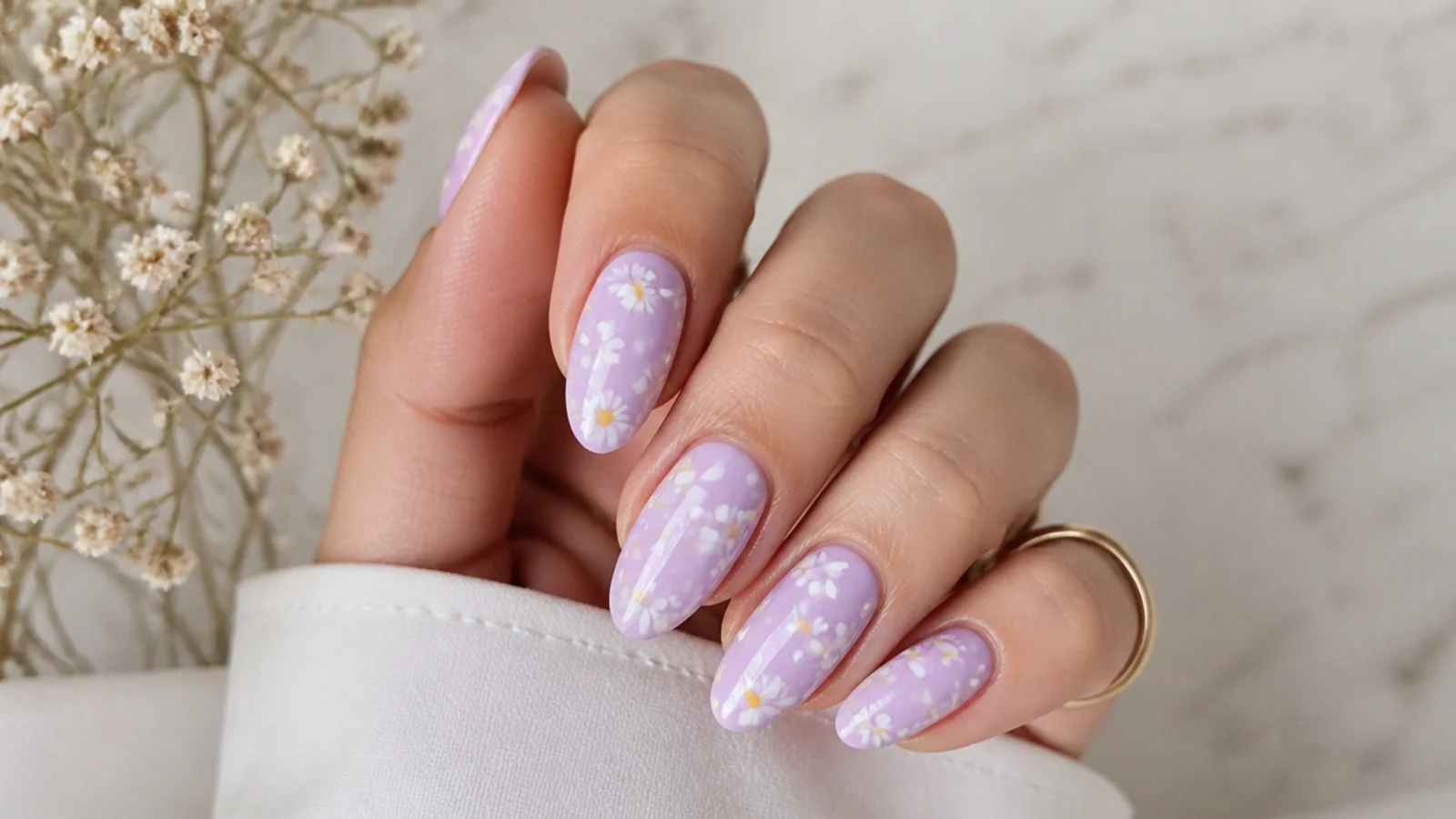 Lavender nails with small white daisies and yellow centers hand-painted on