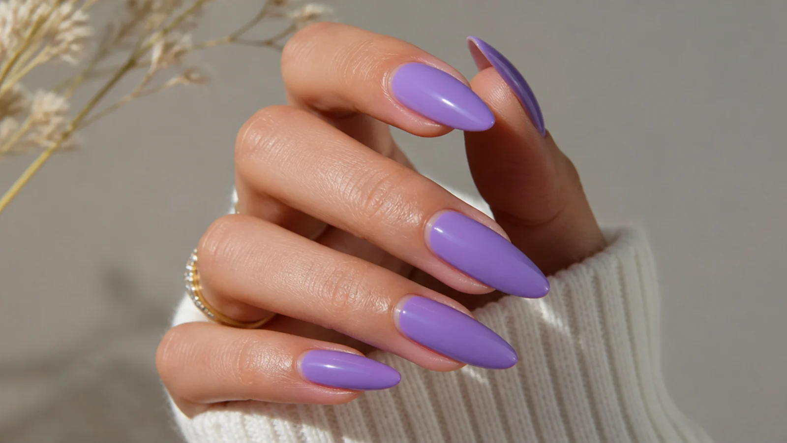 Long almond nails in glossy solid lavender elongating the fingers