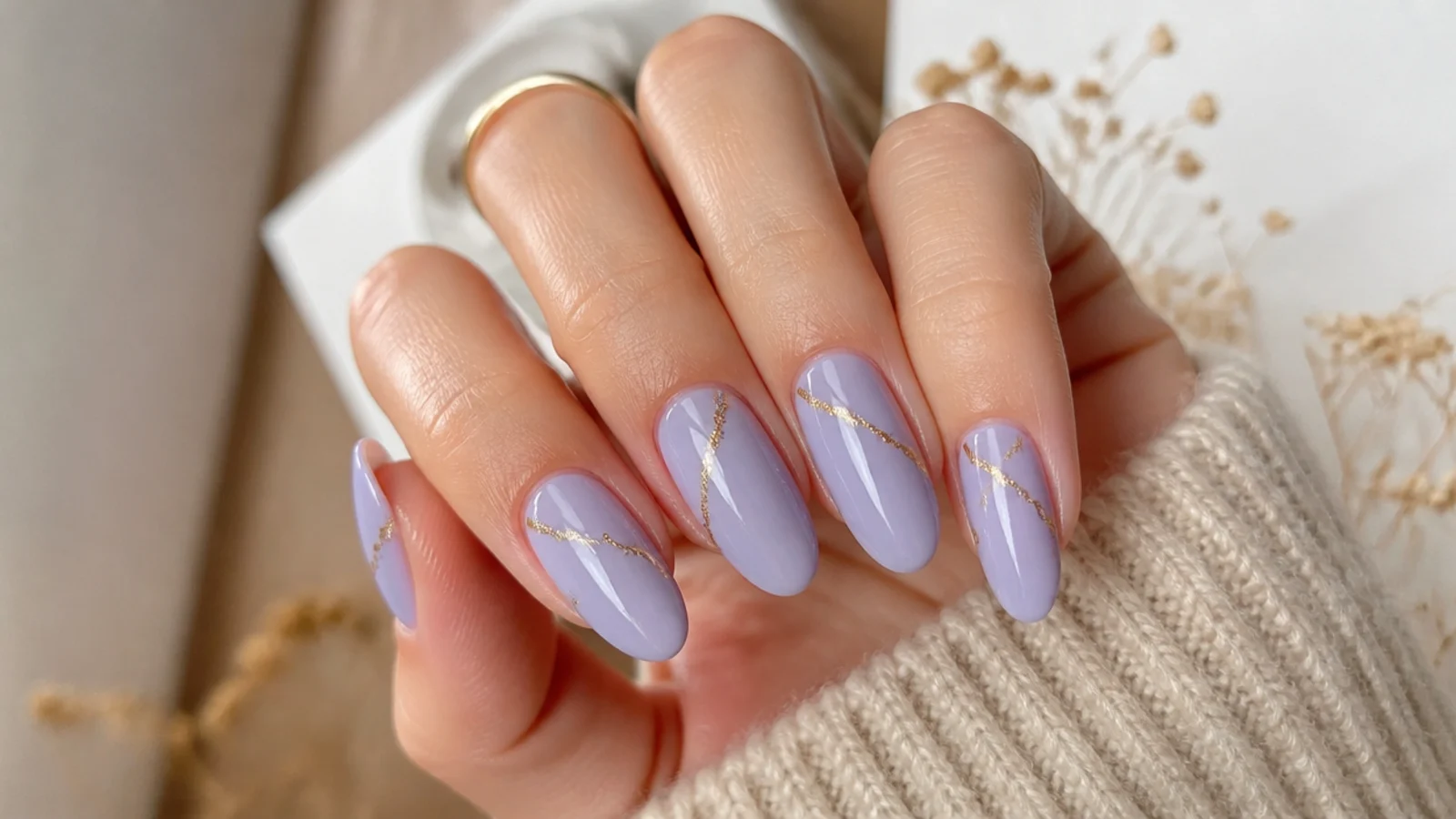 Lavender nails with thin gold foil accent lines