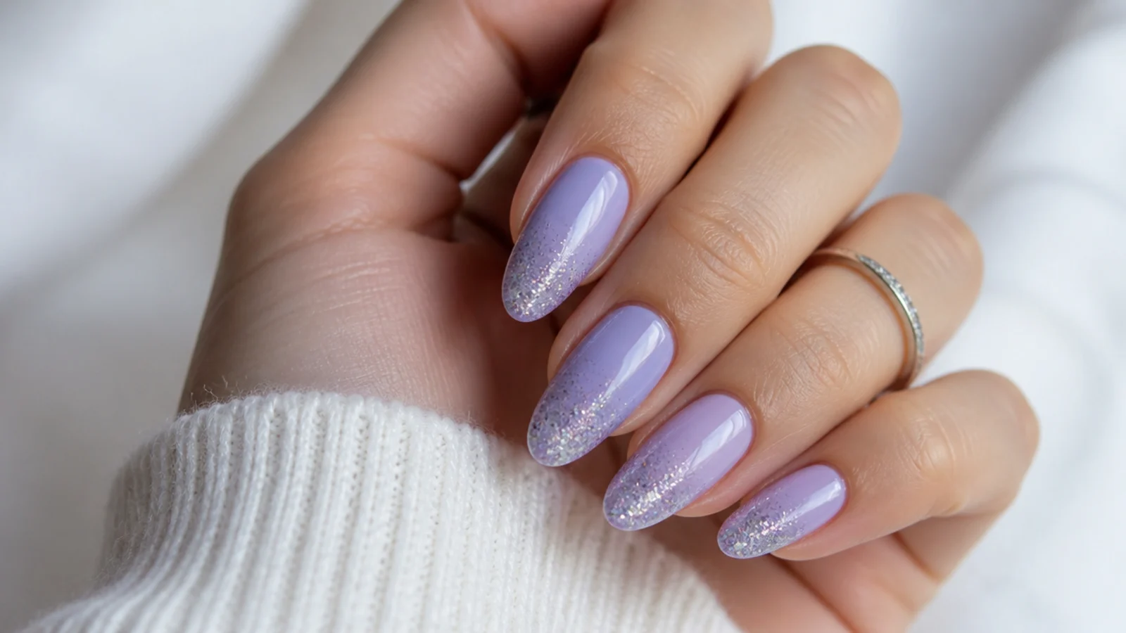 Lavender nails with a glitter gradient toward the tips