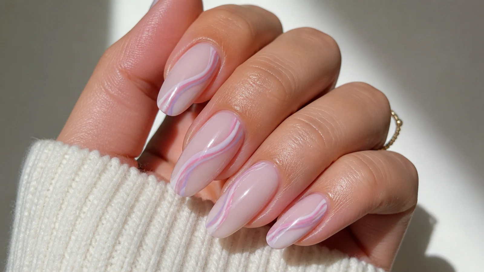 Swirled soft pink and lavender nails on a milky base