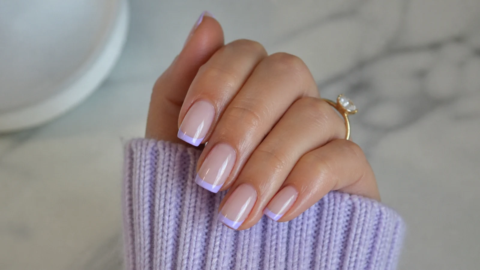 Milky lavender French tips over a sheer natural base