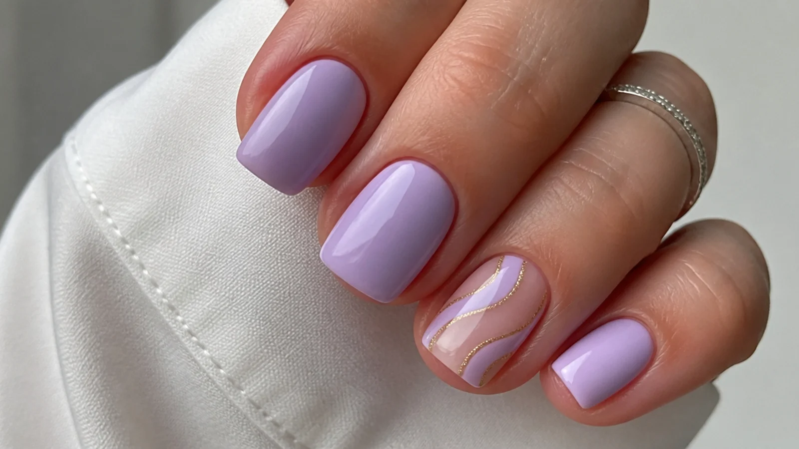 Short squoval lavender nails in a soft opaque lilac