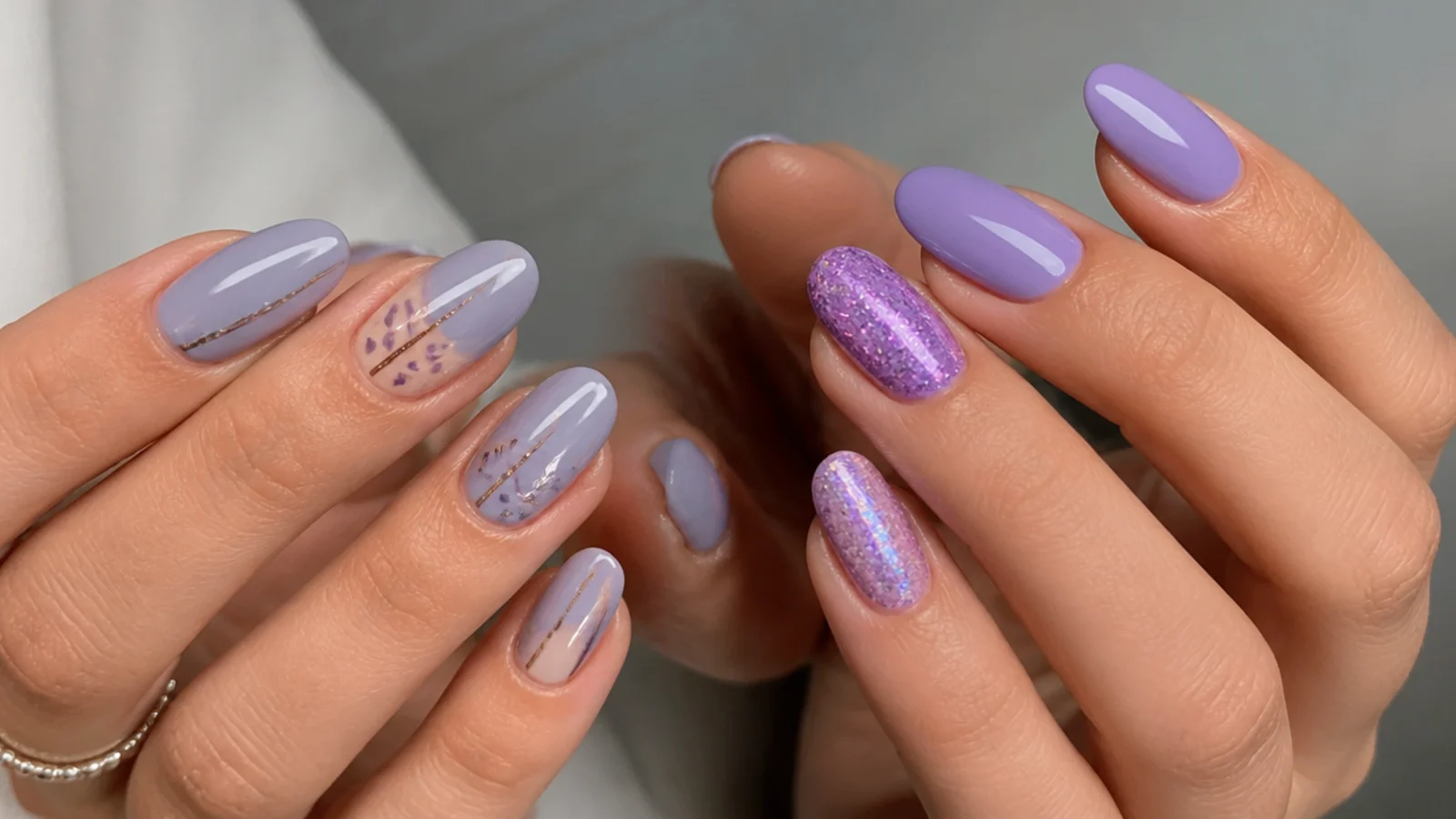 Soft gray-blue lavender nails beside a brighter light purple set