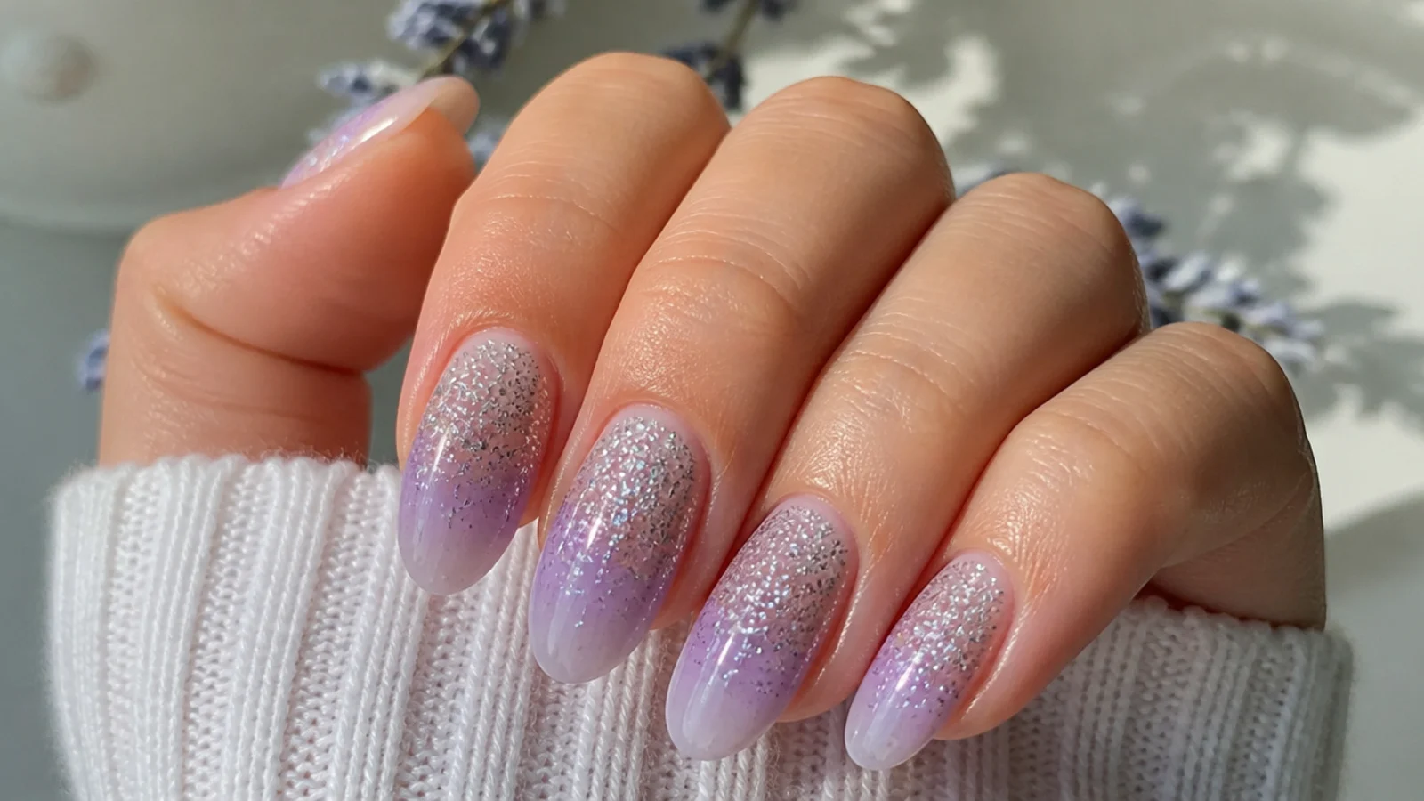 Lavender nails with silver glitter fading from the base to bare tips