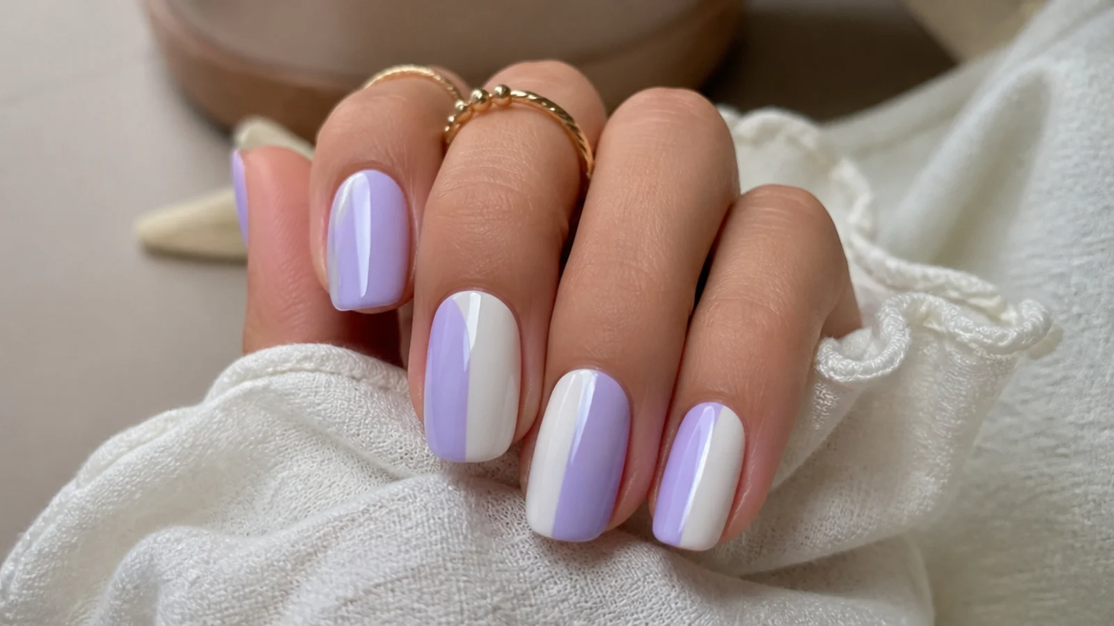 Lavender and white color-block nails with clean geometric halves