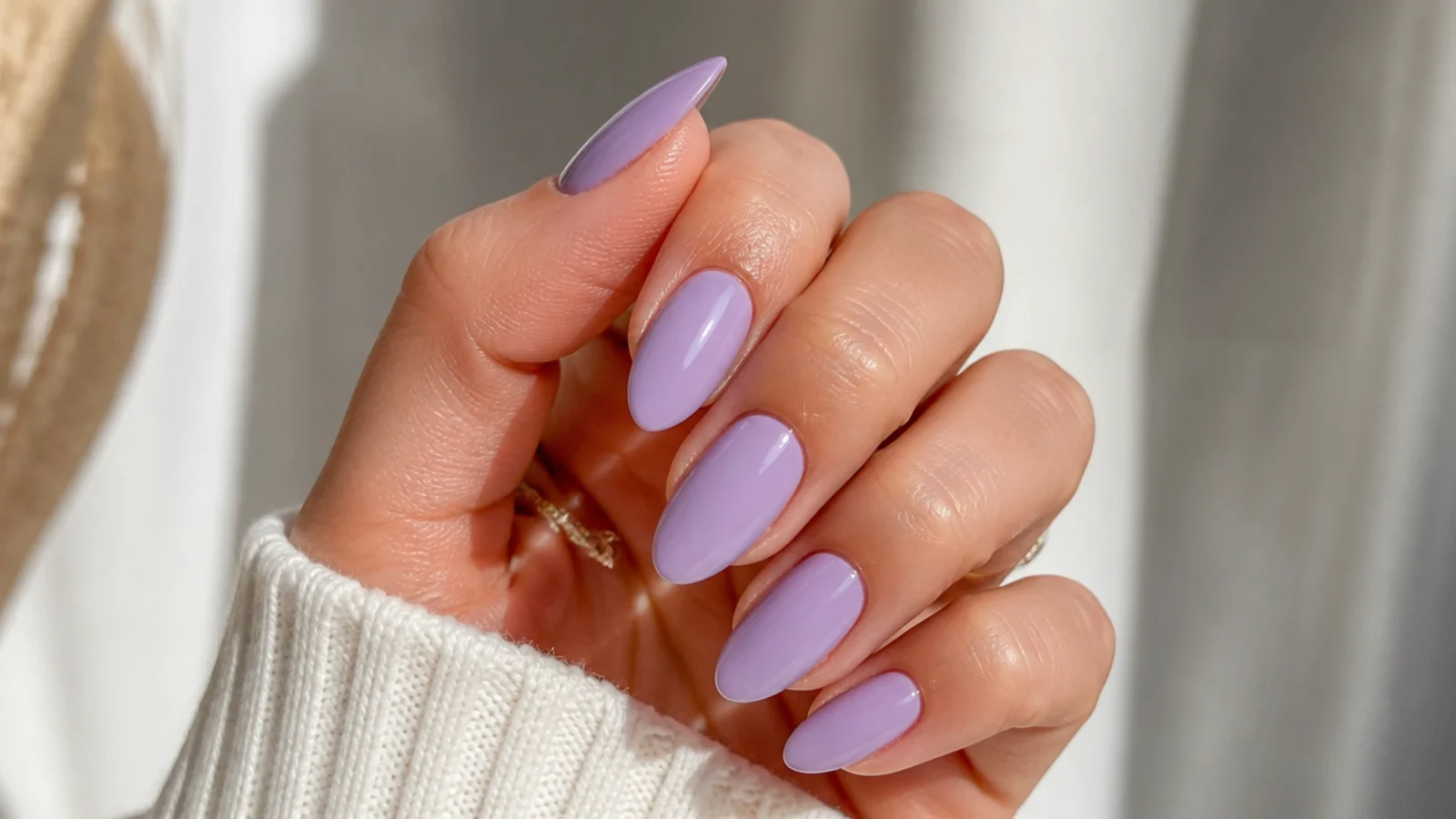 Medium almond nails in soft solid lavender with a smooth finish
