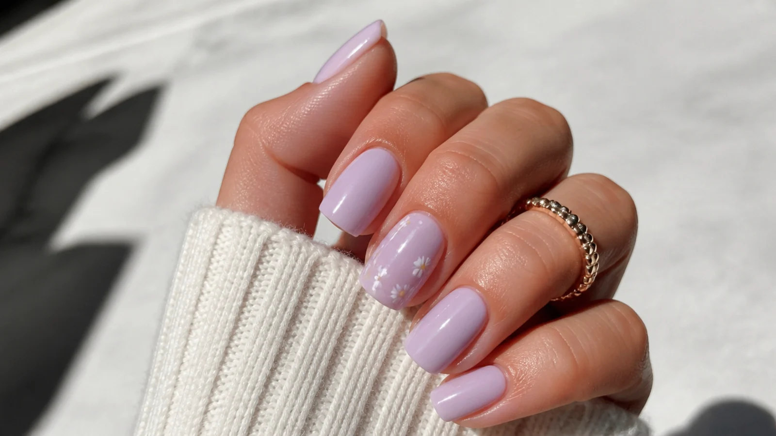 Milky lavender nails with tiny white daisy flowers on one accent nail
