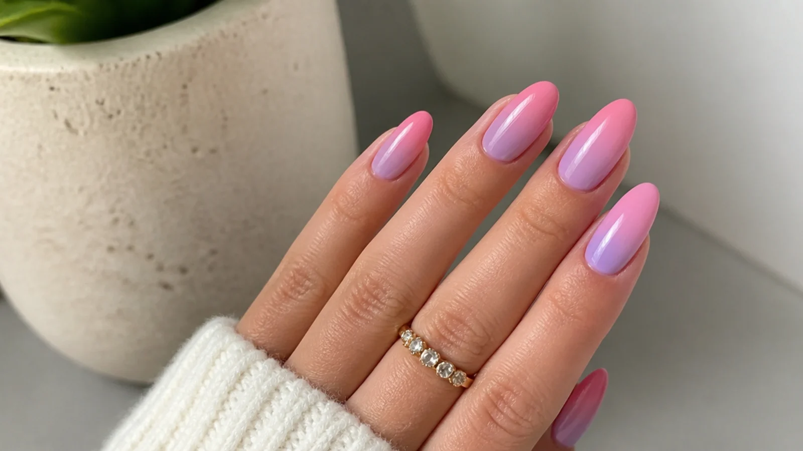 Warm pink-lavender ombre nails fading into soft pink on almond tips