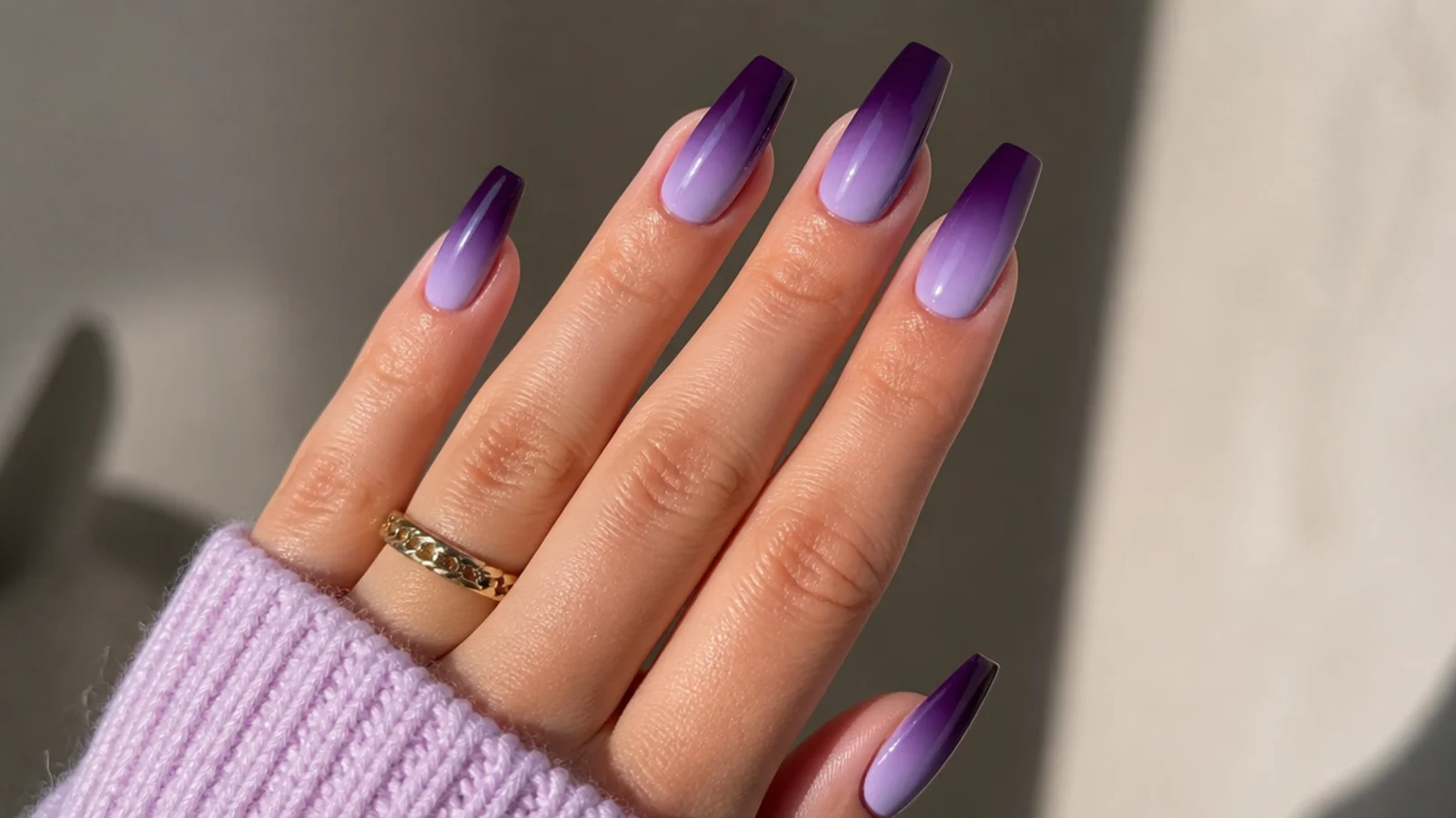 Deep purple fading into light lavender ombre nails on coffin tips