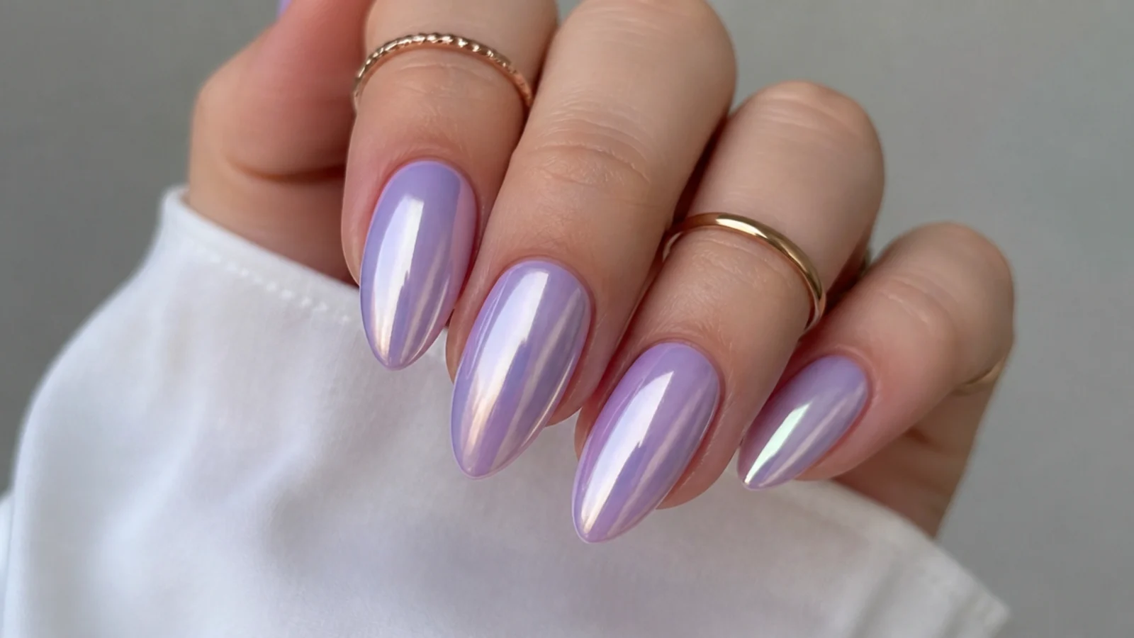 Mirror-chrome lavender ombre nails with a metallic lilac shift on almond tips