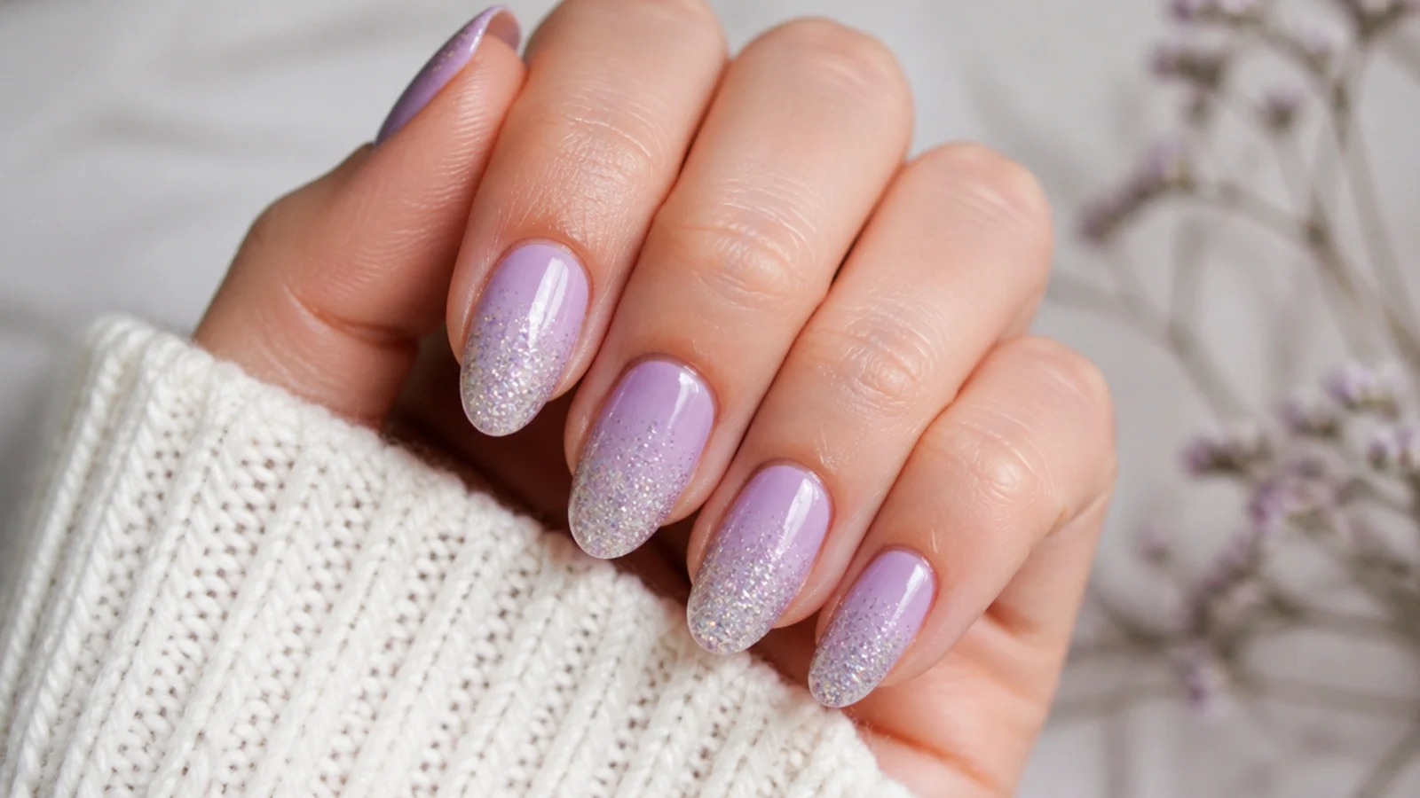 Lavender nails with a fine silver glitter ombre fading from the tip