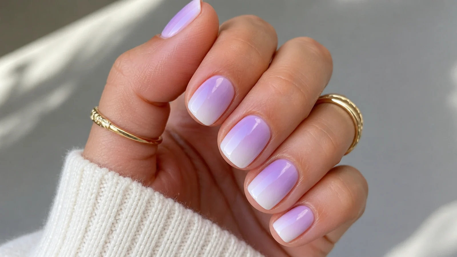 Short squoval nails with a soft lavender to white ombre fade