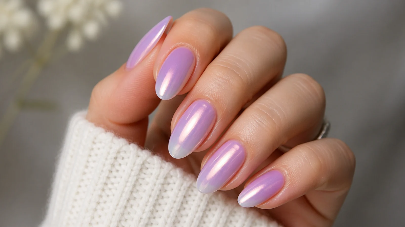 Glazed pearl-finish lavender ombre nails with a soft milky sheen on almond tips