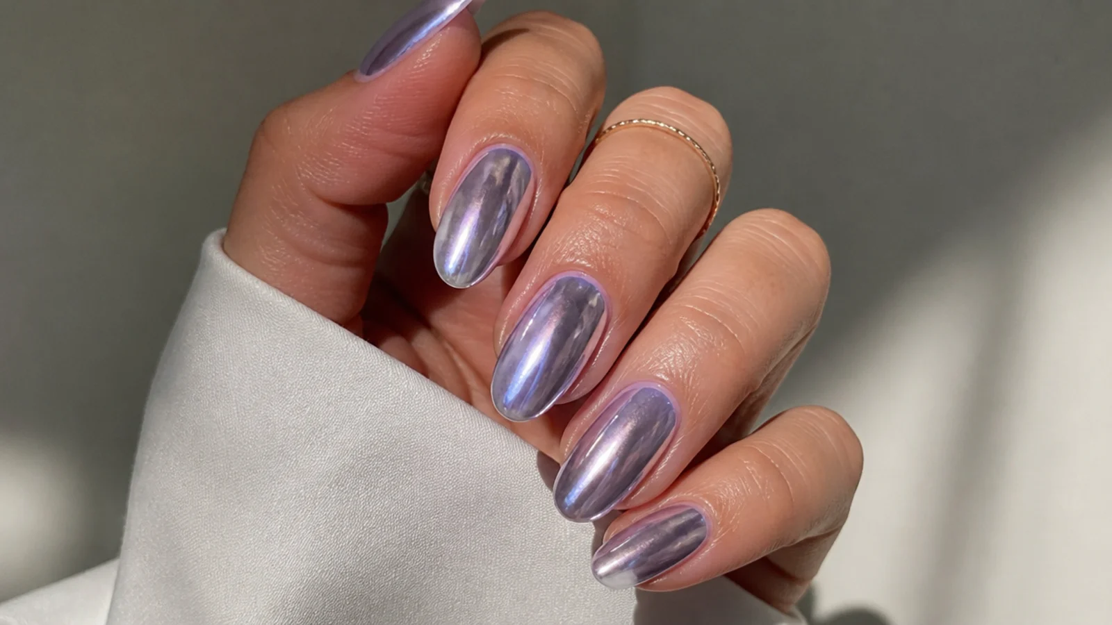High-shine lavender chrome nails with a liquid mirror finish