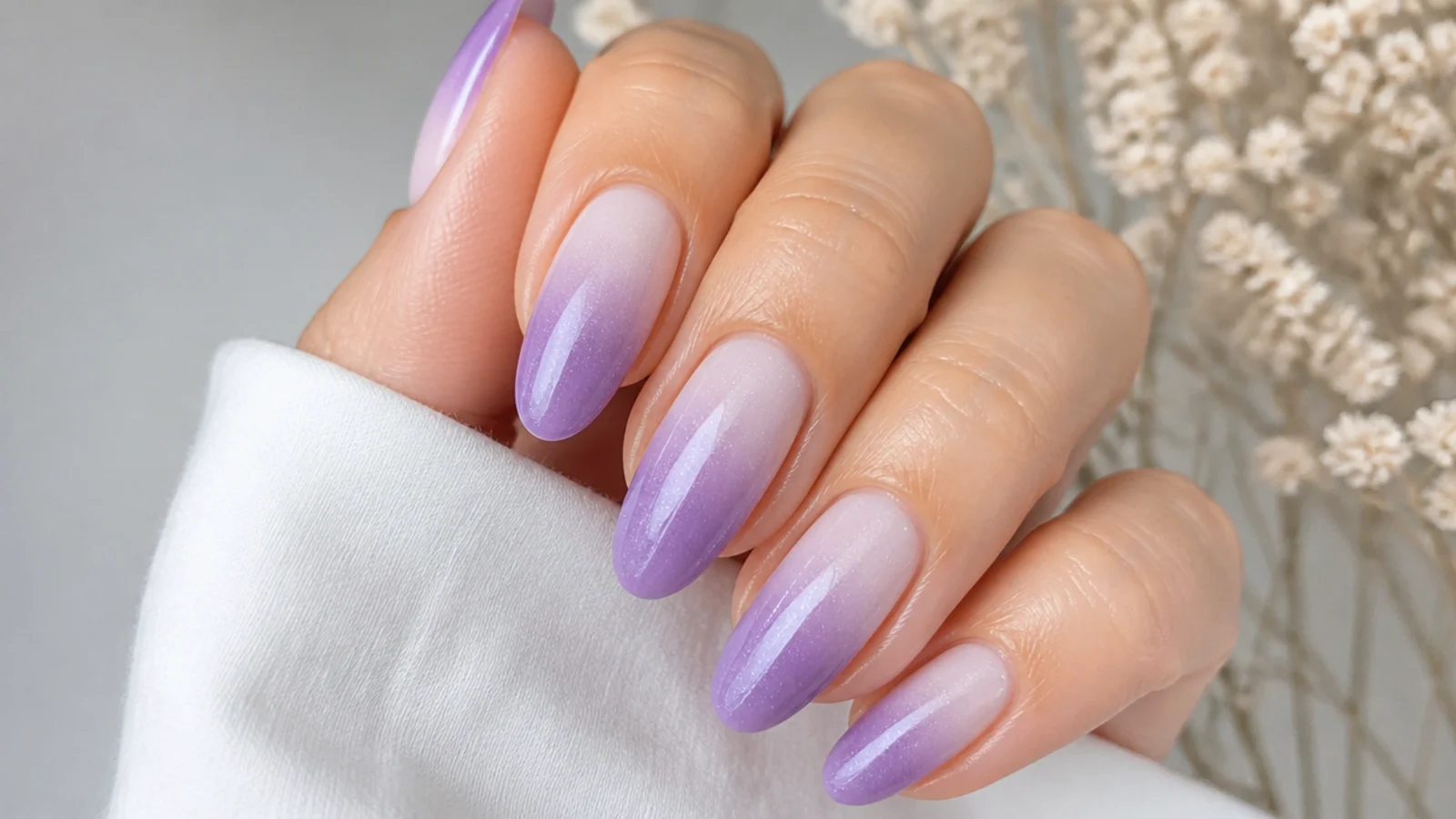 Lavender ombre nails fading from white at the cuticle to deep lilac at the tip