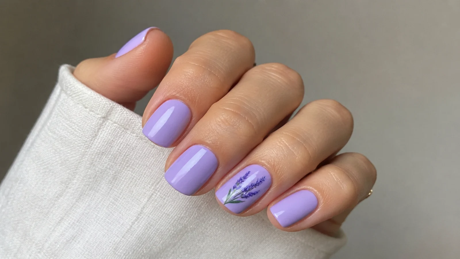 Short squoval lavender nails with a neat glossy finish