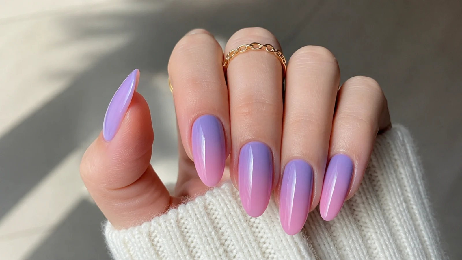 Nails fading from soft lavender at the cuticle to pink at the tip