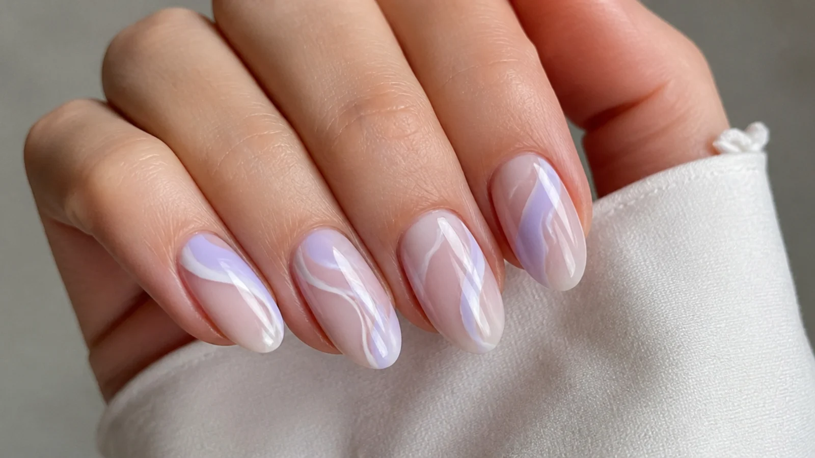 Milky nails with soft lavender and white swirl patterns