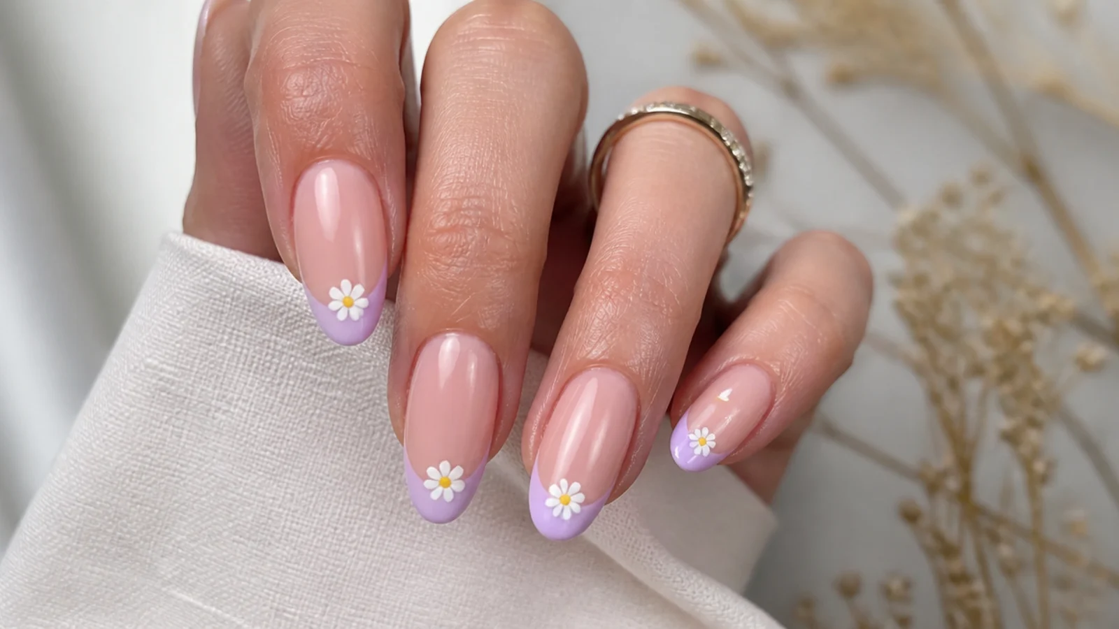 Soft nude nails with lavender French tips and tiny white daisies
