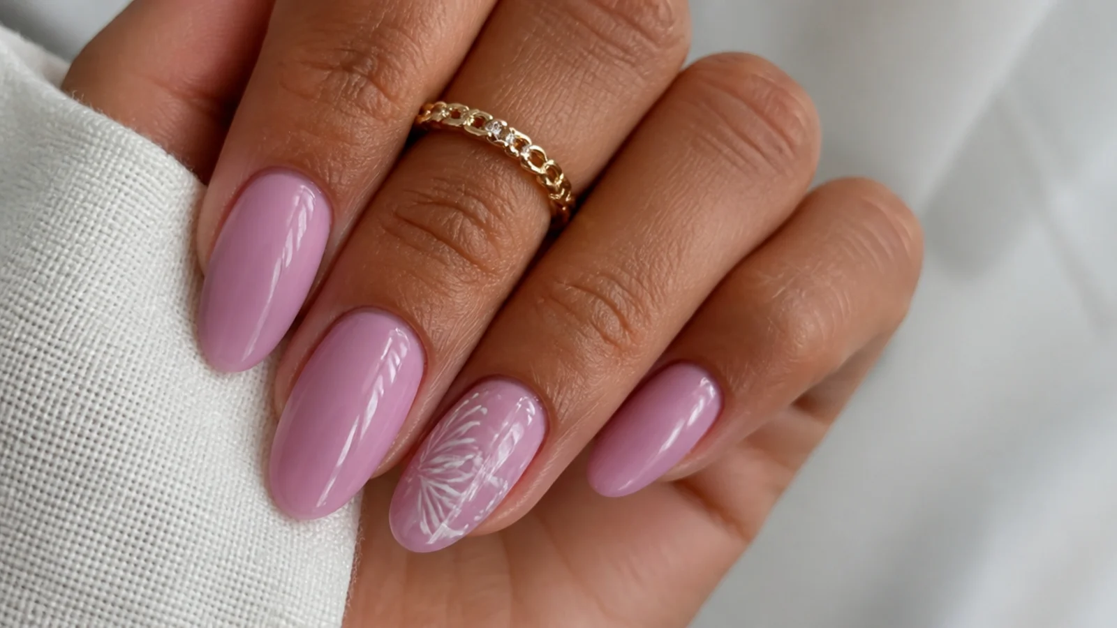 Warm pink-leaning lavender nails on medium-tan almond nails