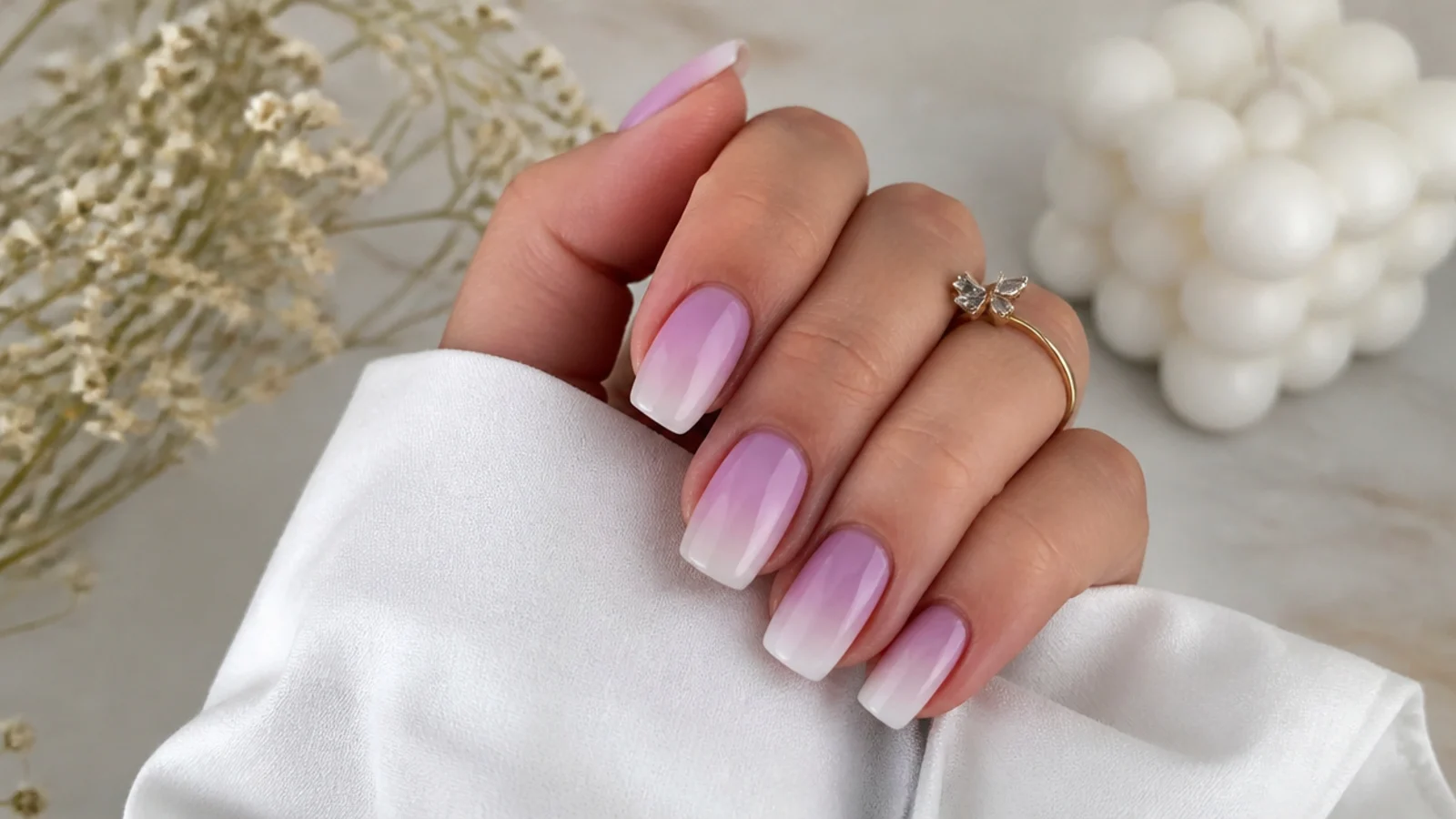 Soft lavender to white ombre nails fading from lilac cuticle to pale tip