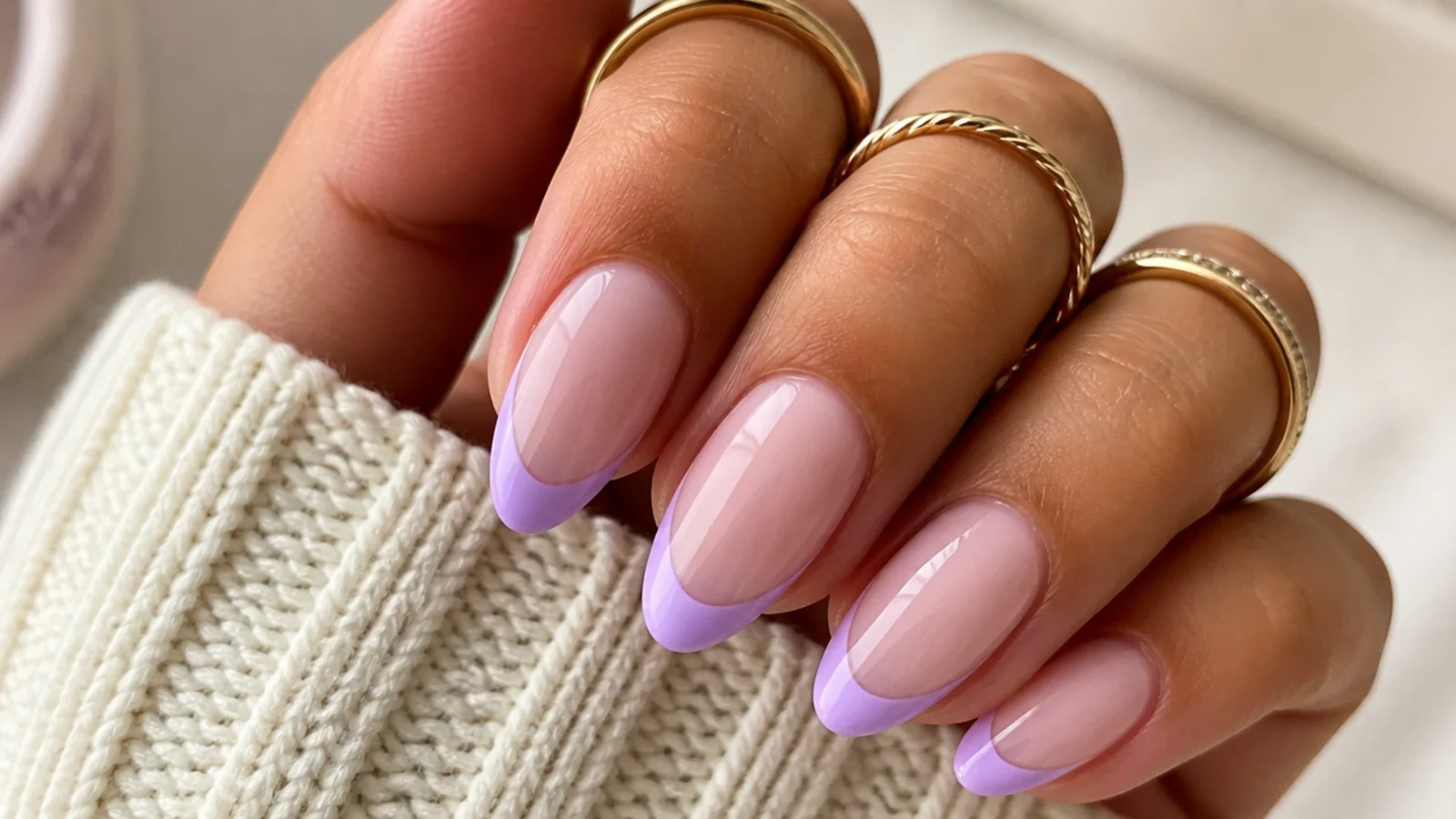 Milky lavender French tip nails with a soft lilac smile line on almond nails