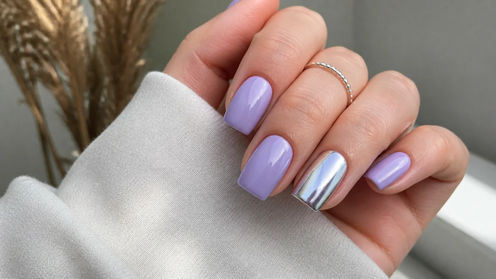 Light lavender nails with one silver chrome accent nail on squoval nails