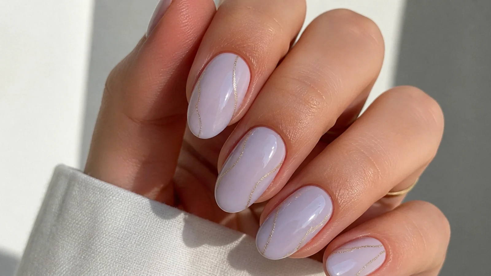 A milky lavender gel layered over a white base to build a soft translucent shade