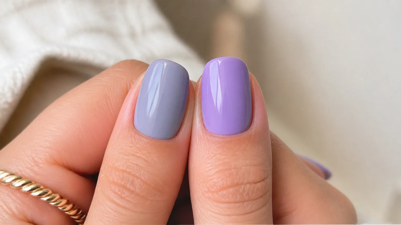 Soft gray-blue lavender nail beside a brighter saturated light purple nail for comparison