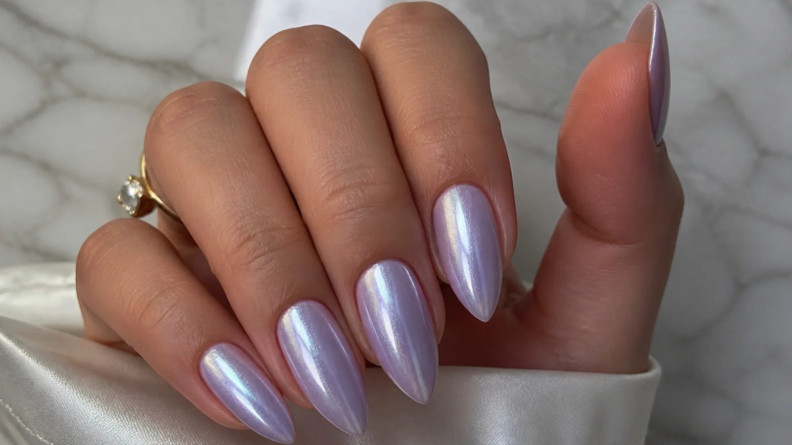 High-shine milky lavender chrome nails with a soft mirror finish